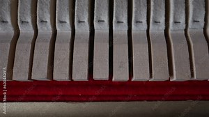 Inside the piano. Close-up view of hammers and strings inside the upright piano.