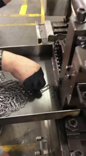 Woman Operating Metal Paperclip Manufacturing Machine