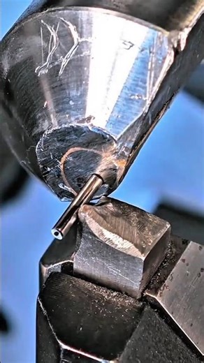 A metal wire being coiled using precision forming tool