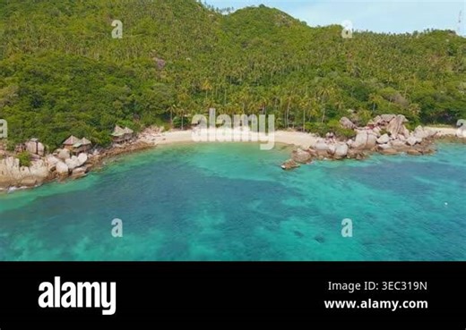 Palmfringed Beach Resort Koh Tao Aerial With Shallow Turquoise Bay Wooden Huts And Coconut Grove Backed Stock Video Footage - Alamy