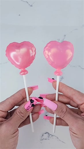 Alexandra Curry | More balloon cake pops! Dipped in a darker shade of Flamingo and finished with Gold Pearl Cake Shimmer. #cakepoptv #cakepops #chocolate... | Instagram