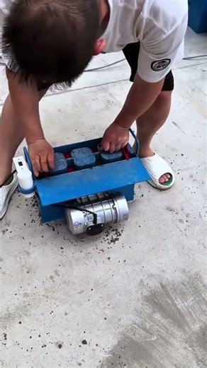 Operating a portable manual cement block making machine to produce three solid paving bricks at once