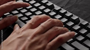 Hands typing rapidly on a mechanical keyboard, focus on fingers, tactile feedback, work environment