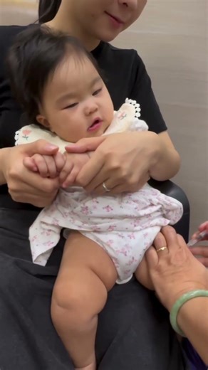 See how the baby is being given an injection.