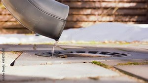 Drainage pipe. Melting snow water flowing from plastic gutter or drain.