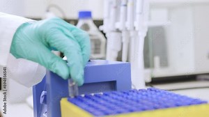 Close up of a chemist shaking samples using a vortex mixer before HPLC analysis in the laboratory