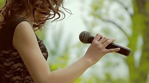 girl dancing with a microphone slow motion video