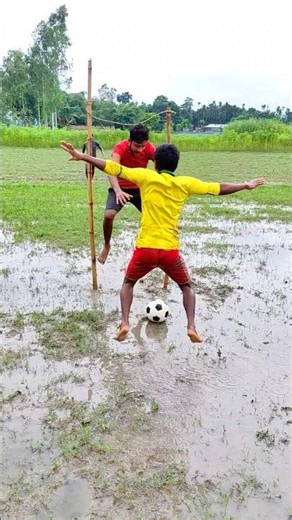 Playing football in water and mud.