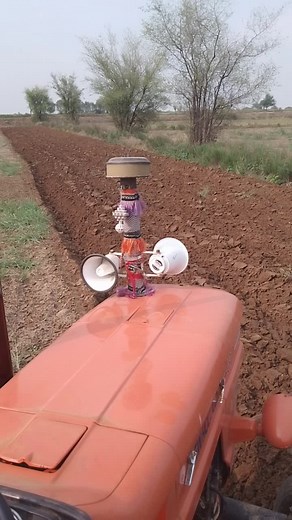 Orange Tractor in Action: Rural Farming Operations