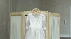 clip-1030488641-bride-undressing-put-on-her-wedding-dress
