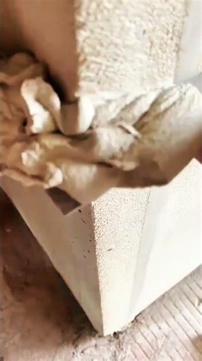 Hand holding square checking corner alignment