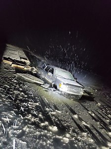 Truck being pulled out of water near Inuvik, N.W.T.