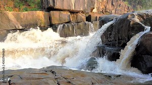 Turbulent monsoon flood water rushing over Pinjari Konda waterfalls, Yeleru River, East Godavar, Duppalapalem, Andhra Pradesh. Fast shutter speed / slow clip speed treatment