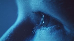 clip-1091253733-young-girl-eye-closeup-loop-blue-light