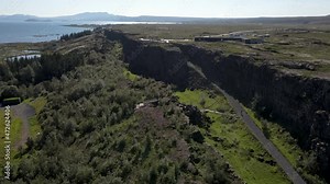 Cinematic aerial footage of Thingvellir national park, Iceland's parliament, the Thingvellir Church and the ruins of old stone shelters, hikes and lake in the golden circule