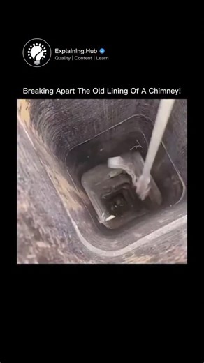 Explaining Everything on Instagram: "A worker swings a heavy hammer attached to a long rope down a chimney shaft, smashing old terracotta flue tiles piece by piece. With every impact, shattered clay cascades downward like a continuous waterfall of debris, creating an oddly satisfying, ASMR-style visual that’s impossible to look away from. This process is known as flue tile breaking, a standard step in chimney relining. Over time, clay liners crack and deteriorate due to heat cycles, moisture, an
