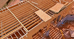 Aerial view a installation of wooden beams at construction the roof truss system of the house
