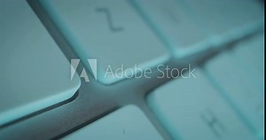 Extreme close-up tracking shot over individual keys of technical computer keyboard