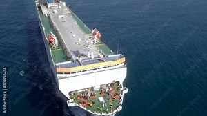 Aerial footage of a Large RoRo (Roll on/off) Vehicle carrier vessel cruising the Mediterranean sea.