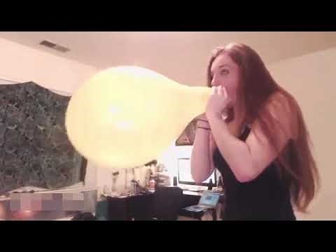 Balloon Girl Blows The Yellow Balloon to its Maximum Capacity