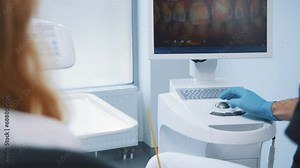 Dental orthodontist consulting female patient showing diagnostic teeth scan on computer screen ultrasound device in professional private hospital office. Stock Video