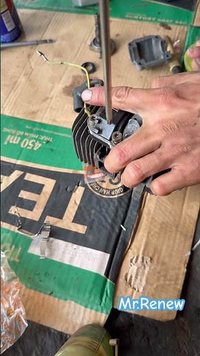 Install the ignition assembly of the Stihl MS180 chainsaw engine.