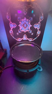 Using SOUND to create ART! 101 Hertz〰️ 🌀Cymatics 101 course is LIVE! 👕T-Shirts 🖼️Prints & More 🔗Link in bio! Cymatics: How sound vibrations influence and organize matter. Frequencies cause particles to arrange into structured, often symmetric patterns. It offers a physical model of wave behavior, helping us understand how energy shapes matter across various mediums. This is water in a dish, vibrating, with lights shining down from above. . . . #sound #frequency #cymatics | Seeing Into The Un