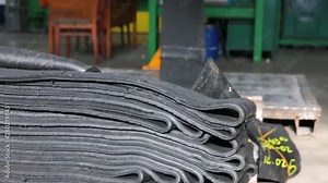 Machine for processing rubber compound into a rubber band. Recycling rubber in the chemical industry. Production process of tires on modern equipment in the factory. Manufacture of tires.