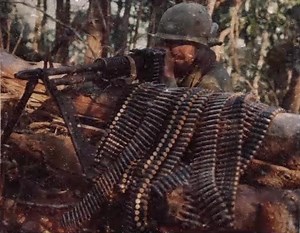 Everything’s Fine! A 173rd Airborne paratrooper holds his ground at Hill 875, armed with a machine gun and a mountain of ammunition. His gaze is focused, yet behind his eyes lie the untold battles of survival. Years later, he would fall victim to a different kind of enemy: cancer, believed to be caused by Agent Orange. The cost of war doesn’t end when the fighting does | Cine Military | Facebook