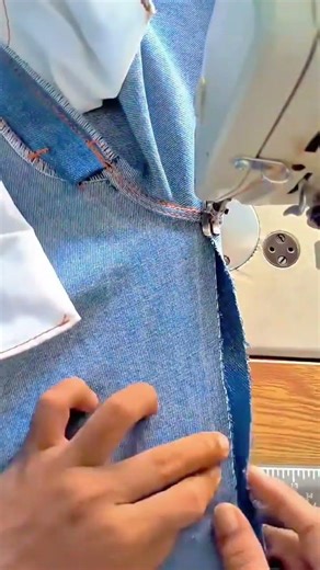 sewing denim fabric with a professional machine to create strong seams for custom jeans or clothing
