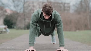 man standing in a plank on the street