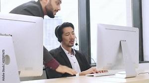 Serious asian male call center service worker arguing with caucasian manager about how to solve customer problems.