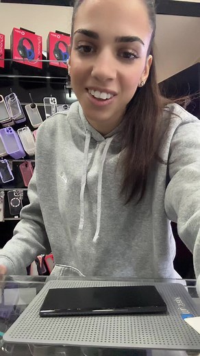 Unboxing a New Smartphone in a Retail Store Setting