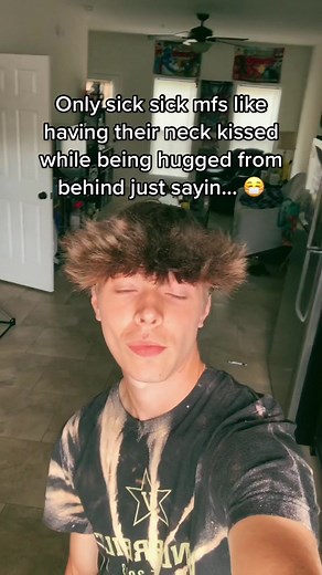 Humorous Neck Kissing Reactions in a Living Room