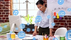 Animation of network of connections with icons over asian businesswoman using computer | Premium Stock Video Footage