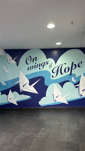 A new mural now welcomes patients in the Gold Garage at Magnolia. 💙 “On Wings of Hope” was inspired by a simple but meaningful goal from Director of Public Safety Tom Carey, to bring warmth, color and comfort to a space so many patients pass through each day. In collaboration with our Arts in Medicine Program, the team created a design rooted in the tradition of folding origami cranes, symbols of healing, peace and hope. For many patients, the Gold Garage is their first stop at Moffitt Cancer C