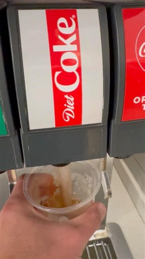 getting Diet Coke soda drink refill at McDonald’s soda fountain machine