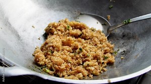 Fried rice being stirred in a wok. A delicious and simple dish. A Culinary Delight of Delicious Fried Rice in Wok
