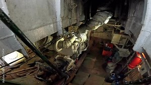 An old diesel engine aboard a ship, showcasing the robust design and engineering of traditional marine engines, used to power vessels and support maritime transport for decades.