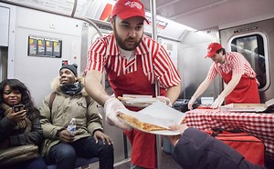 Improv Everywhere Stages a Surprise Pizza Party Aboard a New York City Subway Train
