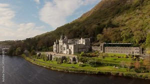 Kylemore Abbey in the Connemara National Park in Ireland Aerial perspective of a historic castle nestled within verdant hills, capturing nature and architecture.