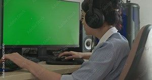 Young Woman Playing Game on Desktop PC Computer Green Screen Monitor. Gamer Sit at Desk Table 4K 10 bit