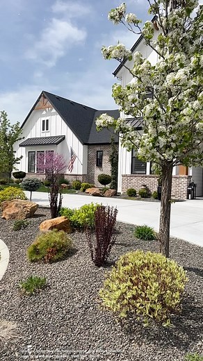 2.4K views | • Spring time in Idaho…when it finally arrives, there’s nothing quite like it.   ☀️  Modern farmhouse, farmhouse, farmhouse exterior, black and White House, brick house, house goals, dream home, spring time, idaho, landscaping, landscape goals, circle drive, German schmear, board and batten, black windows. | A.milesdesign | Facebook