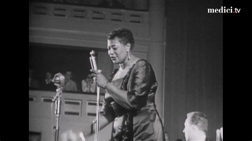 Watch the Lady of Song's witty impersonation of Louis Armstrong, as she flawlessly performs I Can't Give You Anything But Love in Brussels in 1957! At this point Ella was at the peak of her career, a forty-year-old woman with the world on a string. Her band-mates included the likes of bassist Ray Brown, the incomparable Oscar Peterson, the slick Herb Ellis, the metronomic Jo Jones, Roy Eldridge and more. It is about as stellar line-up as possible, and Ella moves from down-tempo masterpieces like