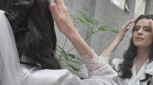 Happy bride looks in the mirror - Free Stock Video