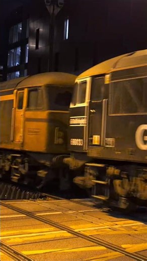 2 class 69s and 3 class 66s on an empty small container train top and tail through Lincoln