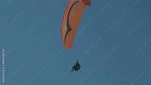 Powered paragliding, paramotoring, paraglider flying in sky over Mediterranean Sea