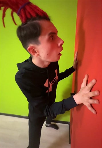 Dynamic Performance with Red Mohawk Hairstyle