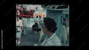 1961 Mother with baby boy in stroller at carnival