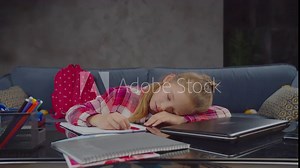Attractive tired elementary school student overworked with study falling asleep at table while doing homework at home. Lovely preadolescent girl sleeping at desk while preparing school assignment.